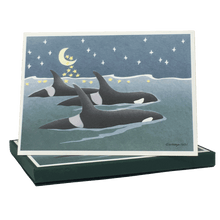 Load image into Gallery viewer, Box of holiday cards with three orcas swimming at the surface of the sea. The moon and stars in the night sky are reflected on the water's surface.
