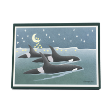 Load image into Gallery viewer, Box of holiday cards with three orcas swimming at the surface of the sea. The moon and stars in the night sky are reflected on the water's surface.