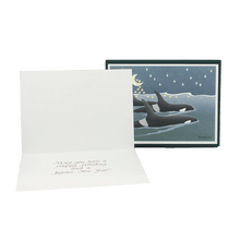 Load image into Gallery viewer, Open holiday card with inside message "May you have a Happy Holiday and a Joyous New Year", in front of a box of holiday cards with three orcas on the cover.