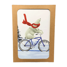Load image into Gallery viewer, Brown box containing holiday cards with polar bear wearing a red scarf, riding a bike through a snowy landscape.