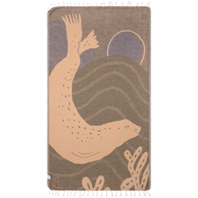 Load image into Gallery viewer, Back of harbor seal beach towel: gray, tan and purple background with harbor seal silhouette and sun outline in light orange