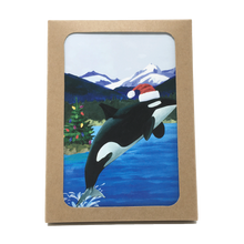 Load image into Gallery viewer, Box of holiday cards with leaping orca wearing Santa hat on cover.