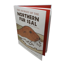Load image into Gallery viewer, "The Journey of the Northern Fur Seal" slightly open, exposing the red and white pages within.