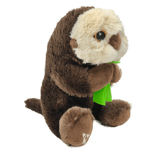 Load image into Gallery viewer, Plush brown and light tan sea otter with embroidered eyes holding bright green kelp. Embroidered feet show white The Marine Mammal Center name and logo in white thread.