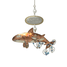 Load image into Gallery viewer, Copper and silver-colored metal orca and baby ornament with blue and white beads. Oval metal hangtag on hanger reads &quot;THE MARINE MAMMAL CENTER&quot;.
