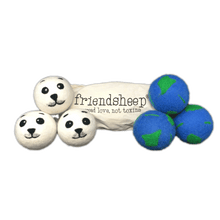 Load image into Gallery viewer, Two sets of three dryer balls in front of cream-colored bag that reads &quot;friendship, spread love, not toxins&quot;. Dryer balls on left side are white with baby seal face design felted on in black and gray. Dryer balls on right are blue with green patches felted on to represent Planet Earth. 
