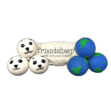 Two sets of three dryer balls in front of cream-colored bag that reads 