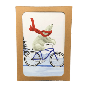 Brown box containing holiday cards with polar bear wearing a red scarf, riding a bike through a snowy landscape.