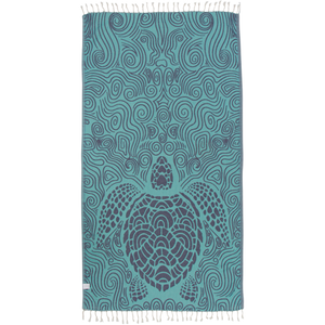 Back of sea turtle towel: mint-green background with block-print style sea turtle and swirl designs in indigo/purple.