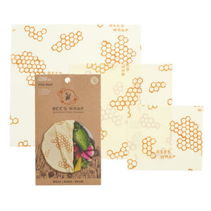 3 reusable wrap squares with honeycomb pattern next to cardstock packaging.