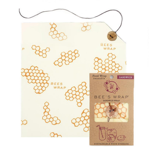 single sheet of honeycomb-patterned beeswax wrap, with wood button and tying string in upper right corner.
