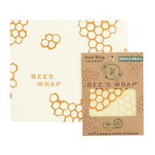 Load image into Gallery viewer, Square sheet of reusable wrap with honeycomb pattern and text &quot;Bees Wrap&quot; next to cardstock package.
