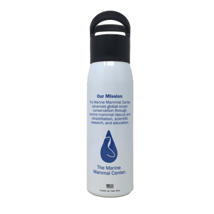 White reusable bottle with black cap and The Marine Mammal Center's logo in blue on back. Text reads "Our Mission: The Marine Mammal Center advances global ocean conservation through marine mammal rescue and rehabilitation, scientific research, and education."