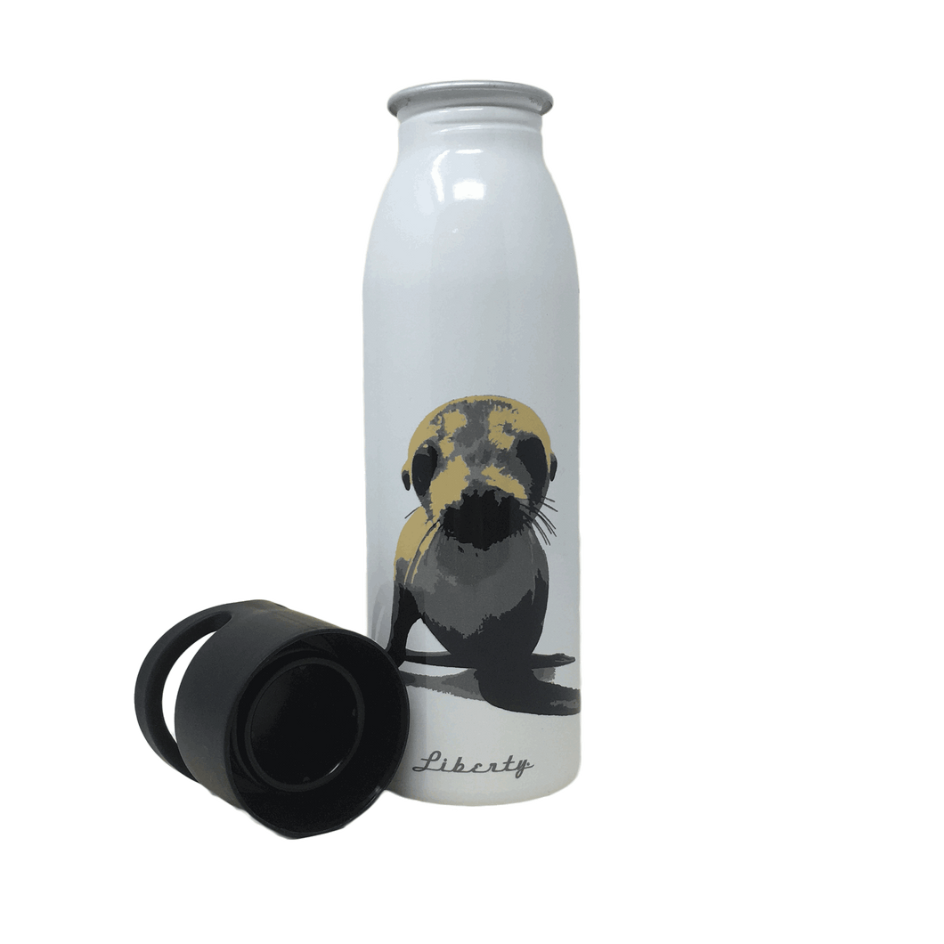 White reusable bottle with sea lion image on front. Black twist-off cap with holding handles sits beside the open bottle