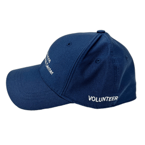 Navy baseball cap with white embroidery of the logo on the front and 'volunteer' on the side.