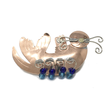 Load image into Gallery viewer, Copper-colored metal pin in shape of sea otter, with blue beads.
