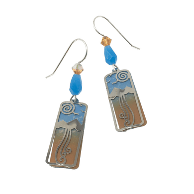 Two long, vertical, rectangular earrings depicting a silver mountain, swirl sun, and rectangular wire overlay to a blue to orange gradient panel beneath.  The rectangles are linked to a blue jewel-shaped bead on a silver wire hook.