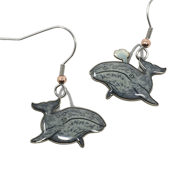 Gray, glossy earrings in shape of swimming gray whales, whale on right is spouting from blowhole. Copper bead at base of ear wires.