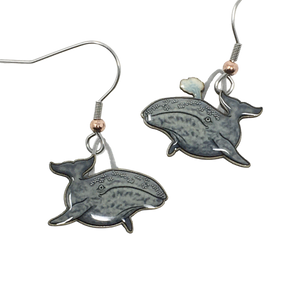 Gray, glossy earrings in shape of swimming gray whales, whale on right is spouting from blowhole. Copper bead at base of ear wires.