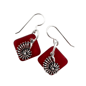 Deep red dangly seaglass earrings with silver nautilus charms and silver ear wires.