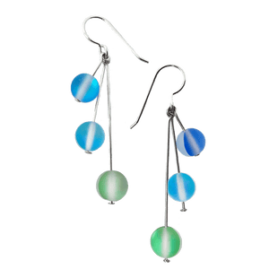 Dangly opalescent seaglass earrings with silver earwires. Three small glass spheres attached to straight silver earwires dangle down in draped on one another.