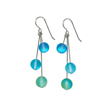 Load image into Gallery viewer, Dangly opalescent seaglass earrings with silver earwires.  Three small glass spheres attached to straight silver earwires dangle down in draped on one another.
