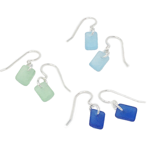 Three sets of dangly rectangular seaglass earrings, in cobalt, turquoise, and seafoam color variants on silver earwires..