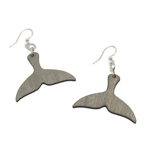 Two light brown wooden earrings in the shape of a whale fluke/tail linked to silver earring hooks.
