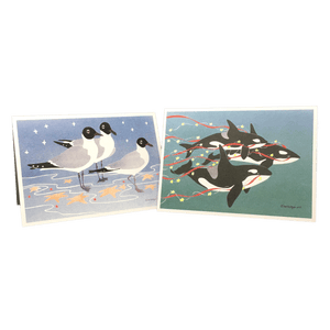 2 holiday cards: 3 gulls standing among red and yellow stars, and 3 orcas swimming in green water trailing red streamers and yellow stars.
