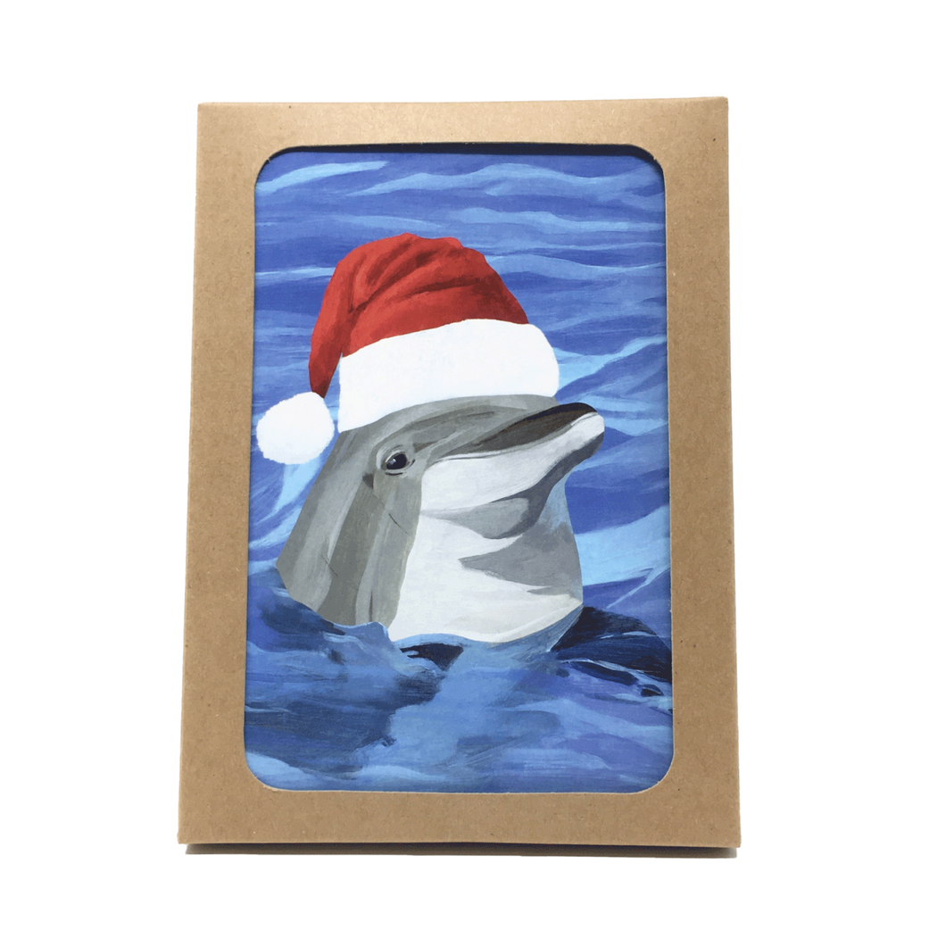 Box of holiday cards with dolphin wearing Santa hat on cover.