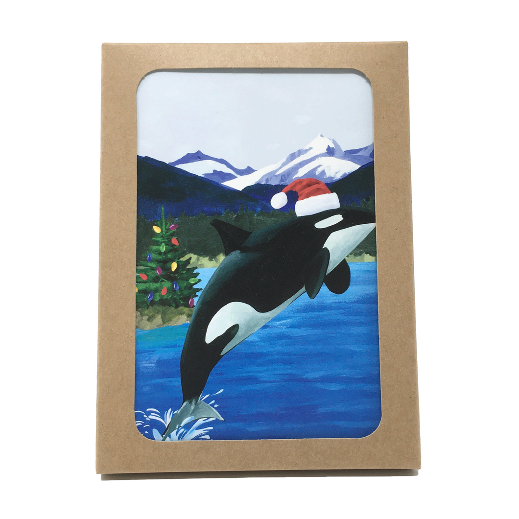 Box of holiday cards with leaping orca wearing Santa hat on cover.