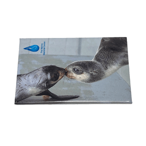 Magnet with photo image of fur seals touching noses and TMMC logo in upper lefthand corner.