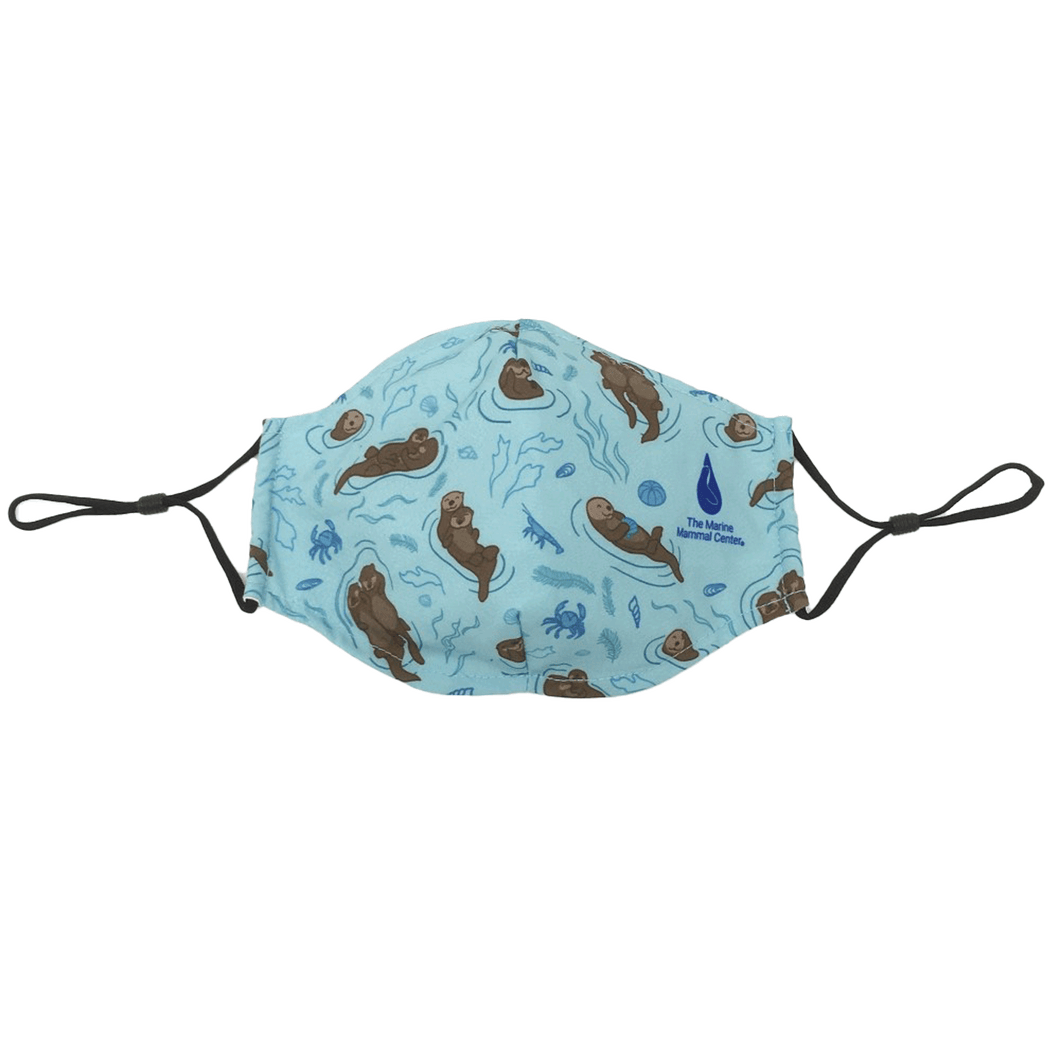 Light blue cinch string facemask with cartoon sea otters and The Marine Mammal Center logo.