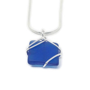 Cobalt blue rectangular glass pendant encased in silver wiring, on silver snake chain.
