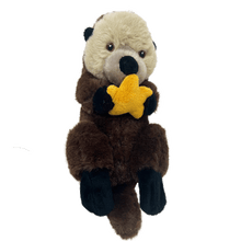 Load image into Gallery viewer, Sea otter plush with embroidered eyes, light brown and dark brown fur, black paws, holding and orange seastar.
