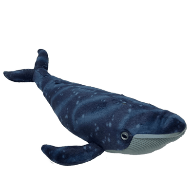 An angled view of a whale plush with dark blue, speckled back and light blue, ribbed underside.