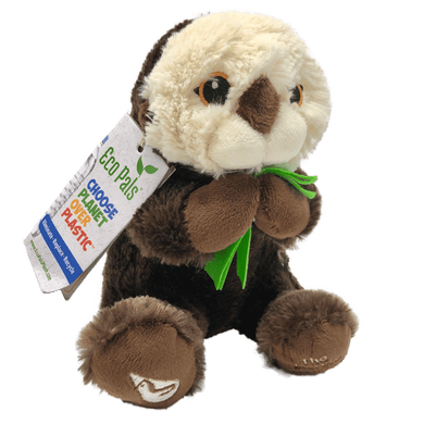 Plush brown and light tan sea otter with embroidered eyes holding bright green kelp.  Embroidered feet show white The Marine Mammal Center name and logo in white thread.  Paper tag reads 