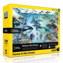 Load image into Gallery viewer, &quot;Home in the Ocean&quot; puzzle box with yellow border, National Geographic logo, a multi-ecosystem ocean image on the front, light blue in color with many different fish, marine mammals, invertebrates, and birds in the image.
