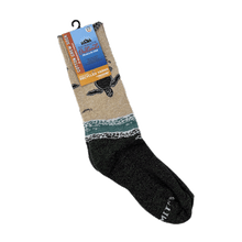 Load image into Gallery viewer, Pair of crew-length socks with design of baby sea turtles entering the ocean from the beach. Tan upper half and forest-green lower half.  Packaging says &quot;Cotton Crew Sock - Socksmith Outlands, Made in the USA - Recycled Yarns&quot;
