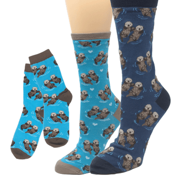 Socks in various shades of blue featuring pattern of sea otters holding hands