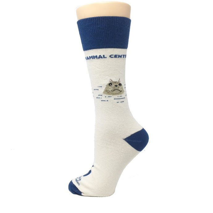 Primarily white sock with deep blue accents, depicting TMMC logoing and a seal popping its face out of the water.