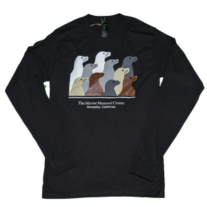 Black long-sleeve t-shirt featuring design with 10 sea lion profiles in white, gray, tan, and brown on front. Text "The Marine Mammal Center Sausalito, California" beneath image.