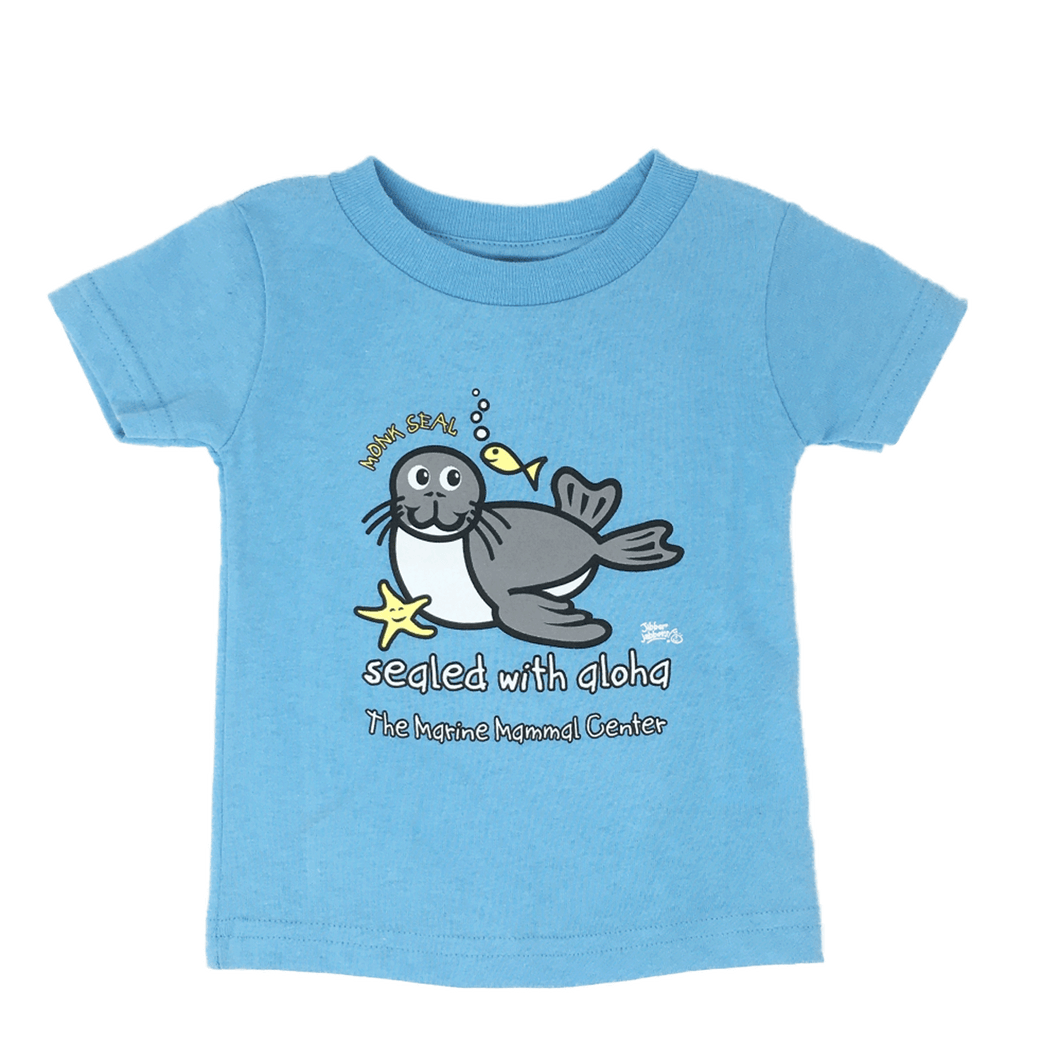 Light blue short sleeve t-shirt with a cartoon image of a grey and white monk seal with small yellow fish and seastar, words 
