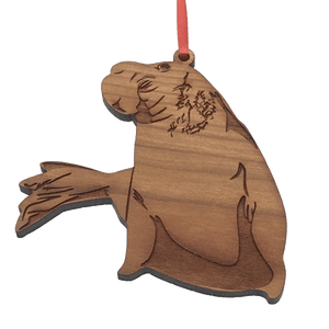 2D laser-cut wood elephant seal ornament hanging from red ribbon.