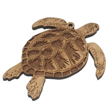 Load image into Gallery viewer, Cherry wood ornament in shape of sea turtle, with laser-cut patterns on shell..
