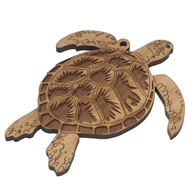Cherry wood ornament in shape of sea turtle, with laser-cut patterns on shell..